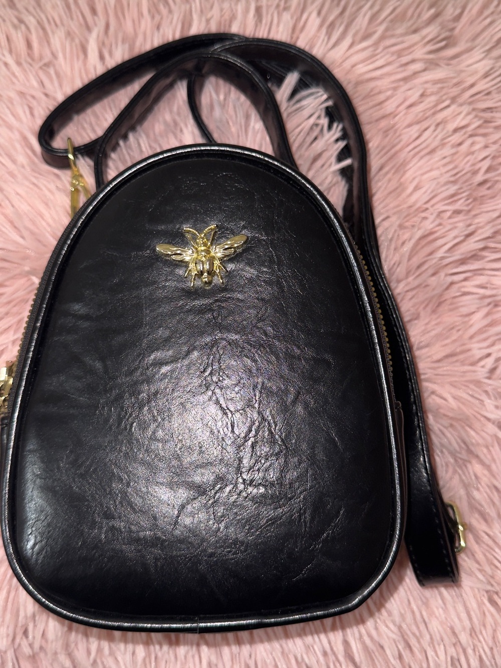 Black faux leather crossbody bag with gold hardware